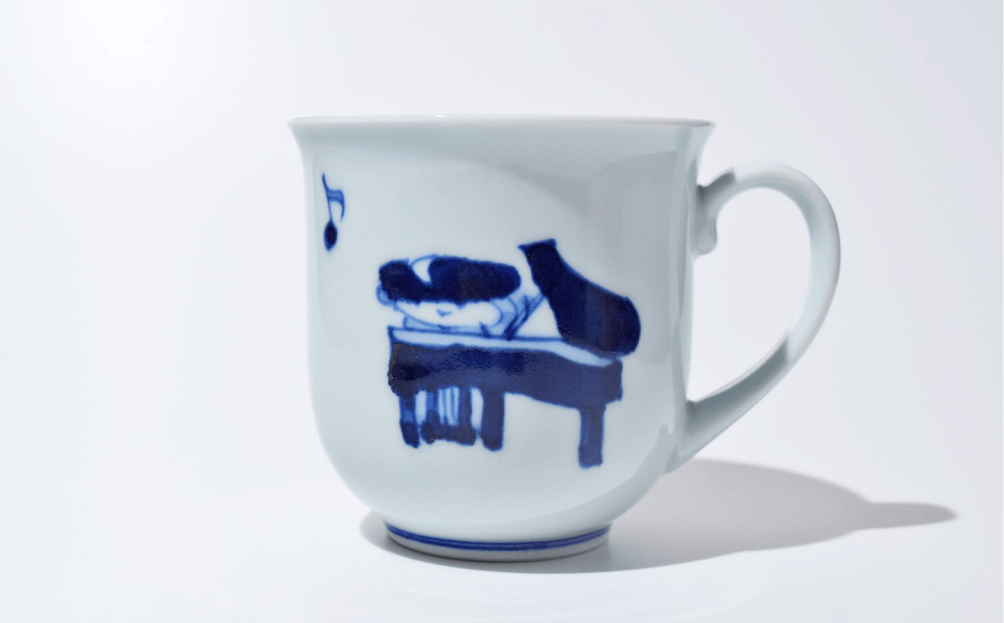 
            佐賀県で暮らす児童養護施設のこどもの就労支援協力企業「しん窯」の有田焼南蛮人音反マグカップ ピアノ
          